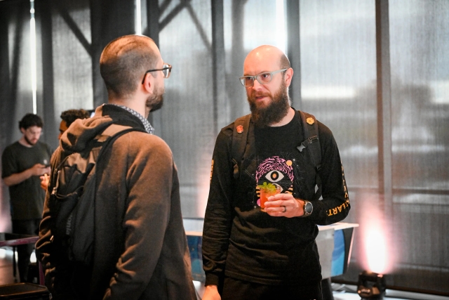 Two male guests networking.