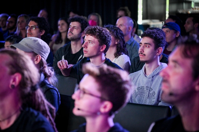 Audience members listening to the keynote speaker.