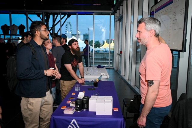 Guests listen intently as Sentry explains their product at their sponsor booth.