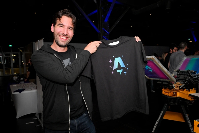 Fred K. Schott poses with a black Astro logo printed t-shirt.